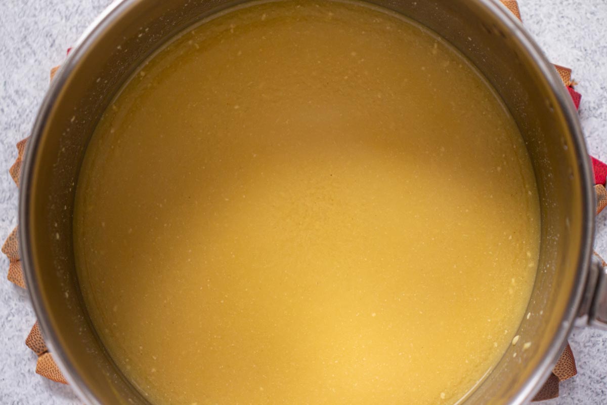 An opaque broth mixture in a saucepan.