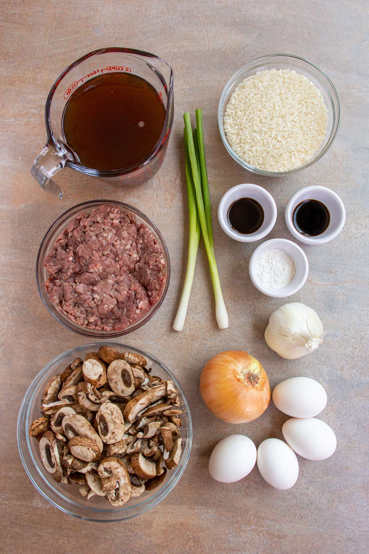 Ingredients for Hawaiian loco moco on a beige background.