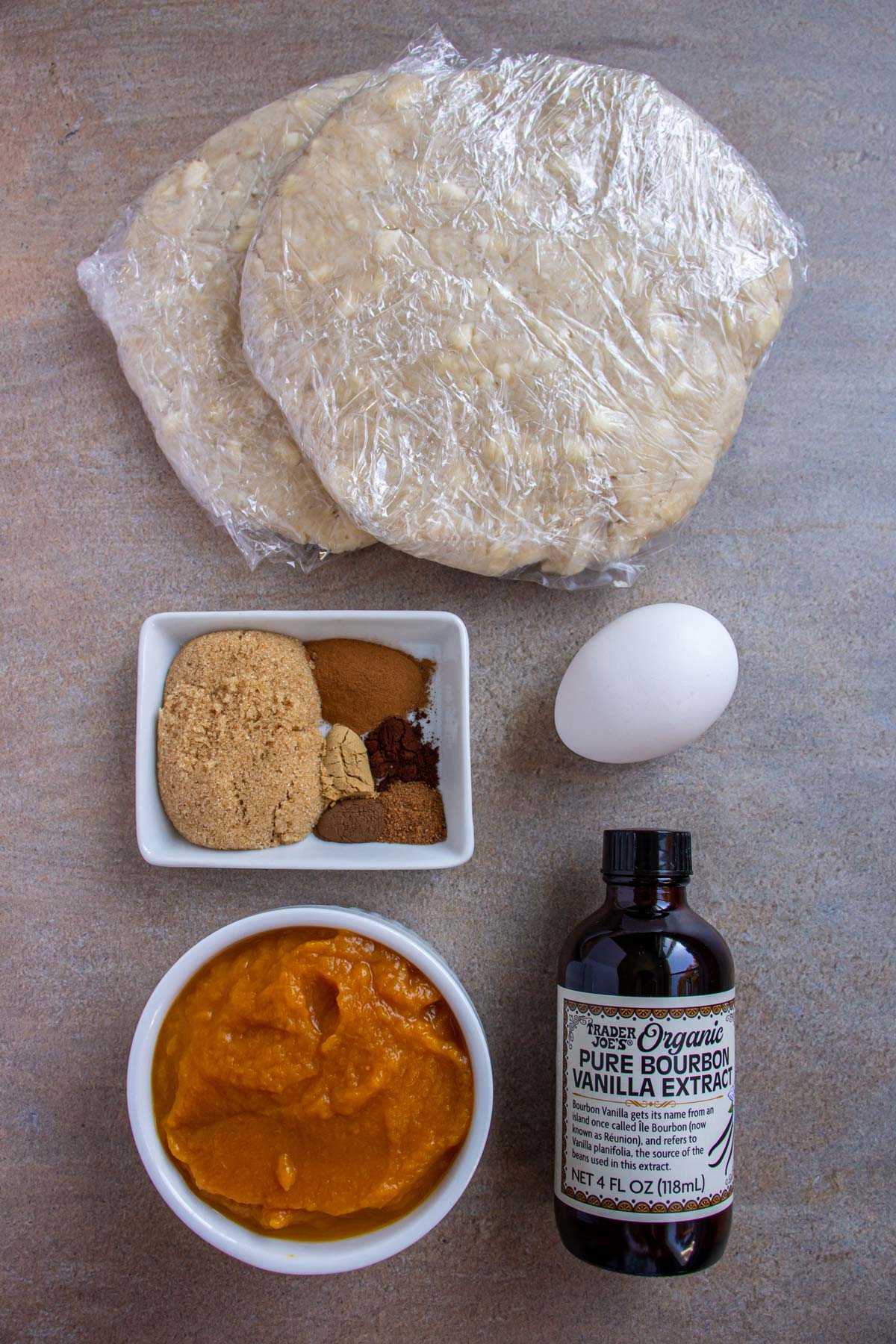 Ingredients for pumpkin pasties on a beige background.