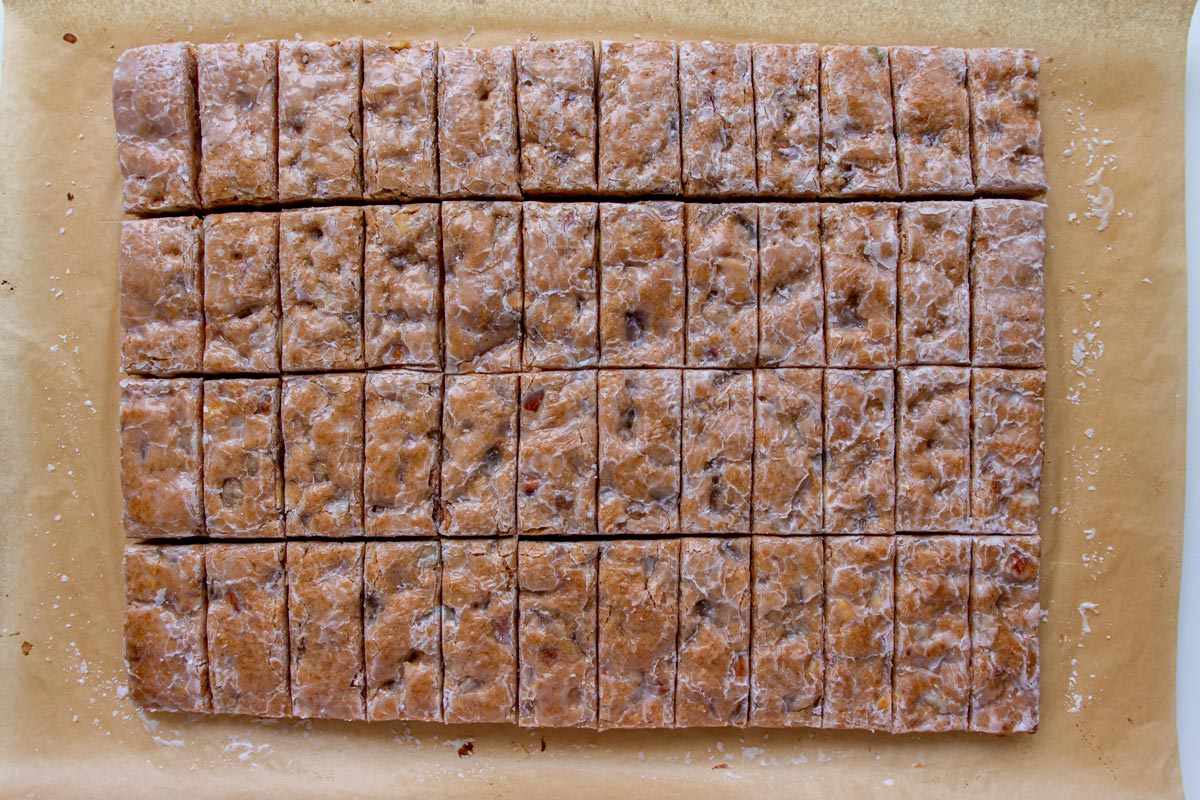 A rectangular slab of baked Basler Läckerli dough cut into small rectangular bars.