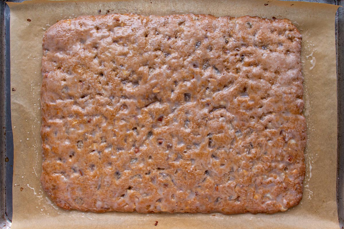 A rectangular slab of golden brown baked dough brushed with a thin glaze.
