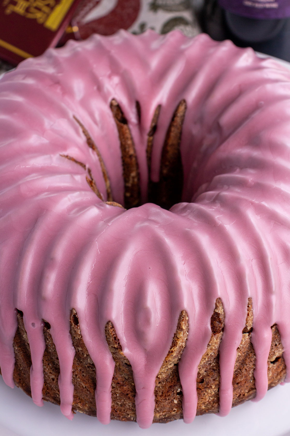 Closeup of a Bundt cake with pink glaze dripping down the sides.