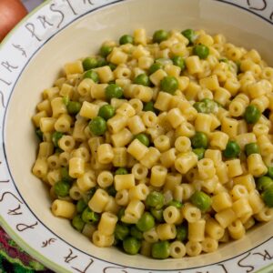 Closeup of a bowl of ditalini pasta and peas.