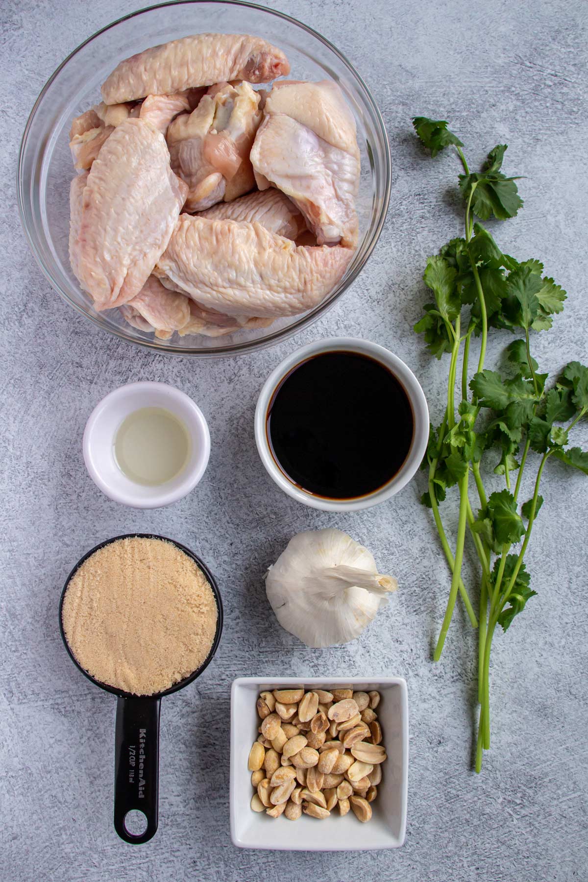 Ingredients for Vietnamese chicken wings on a light grey background.