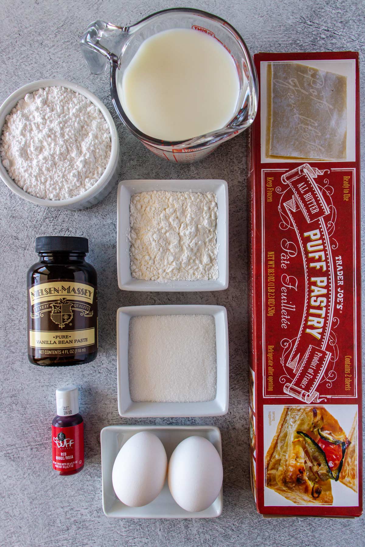 Ingredients for Dutch tompouce pastry on a light grey background.