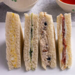 Closeup of 4 Harry Potter inspired tea sandwiches showing off their colorful fillings.