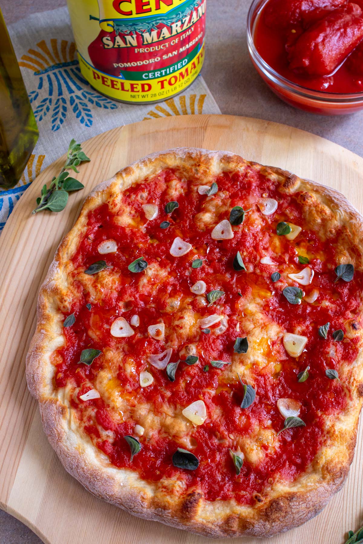A Neapolitan style pizza marinara with sliced garlic and fresh oregano and no cheese.