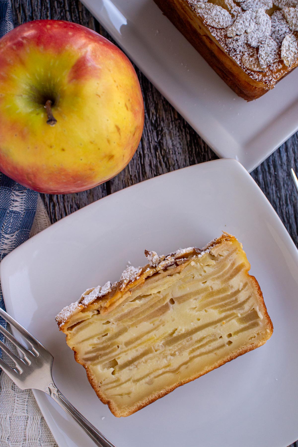 Cross-section of a slice of Gâteau Invisible showing the thin slices of apples.