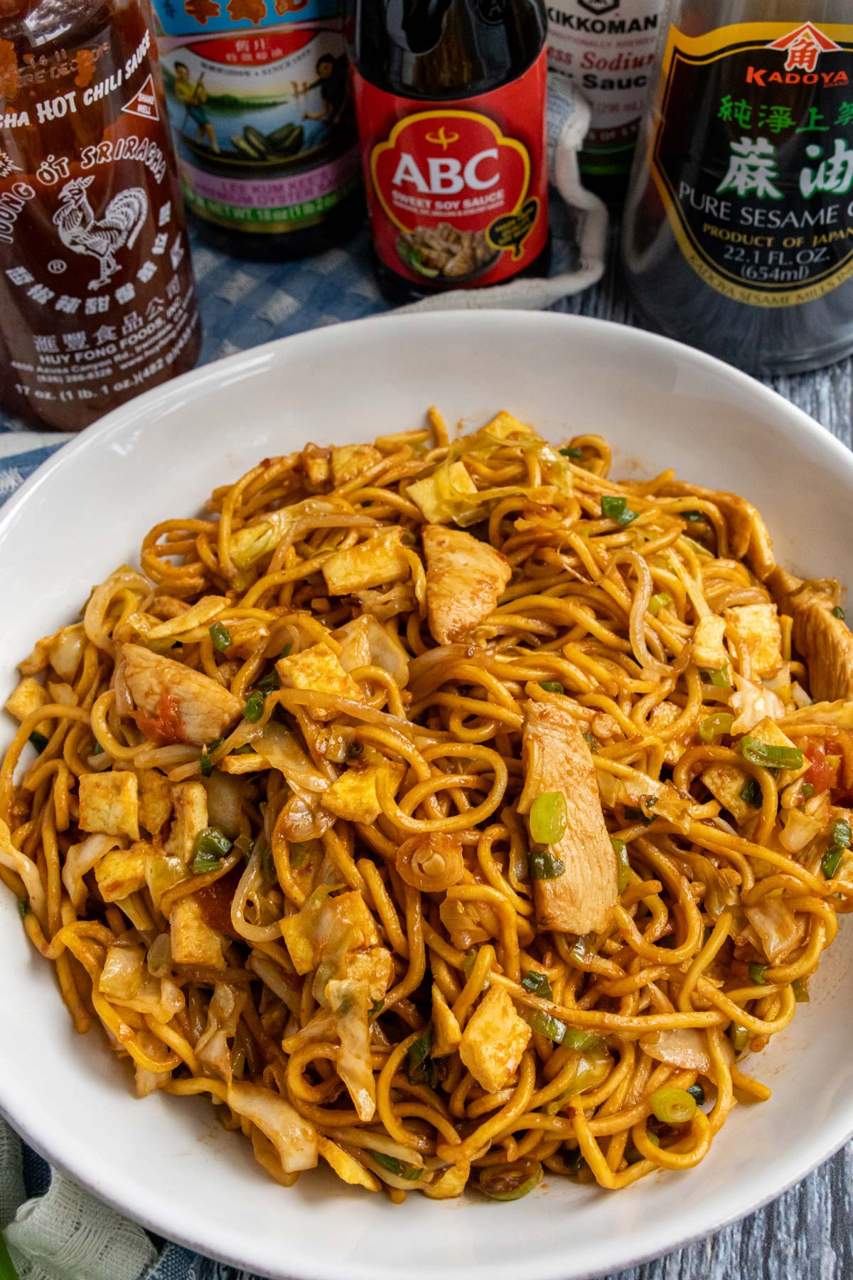 Mie goreng stir-fried noodles with chicken and diced omelet in a white bowl.