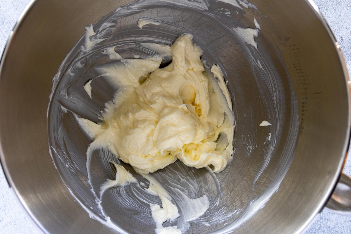 Soft butter beaten with sugar in a metal mixing bowl.