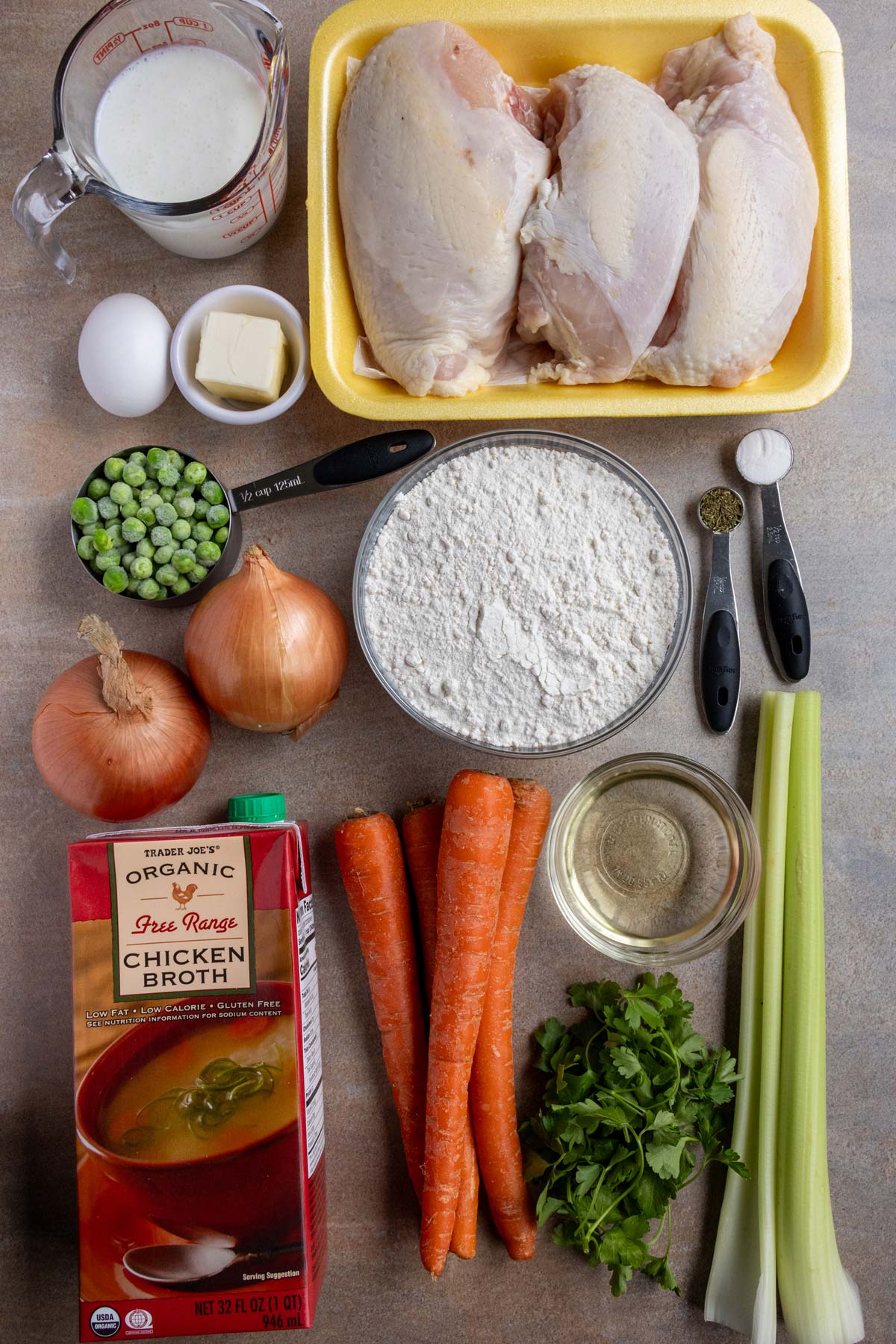 Ingredients for healthier chicken and dumplings on a beige background.