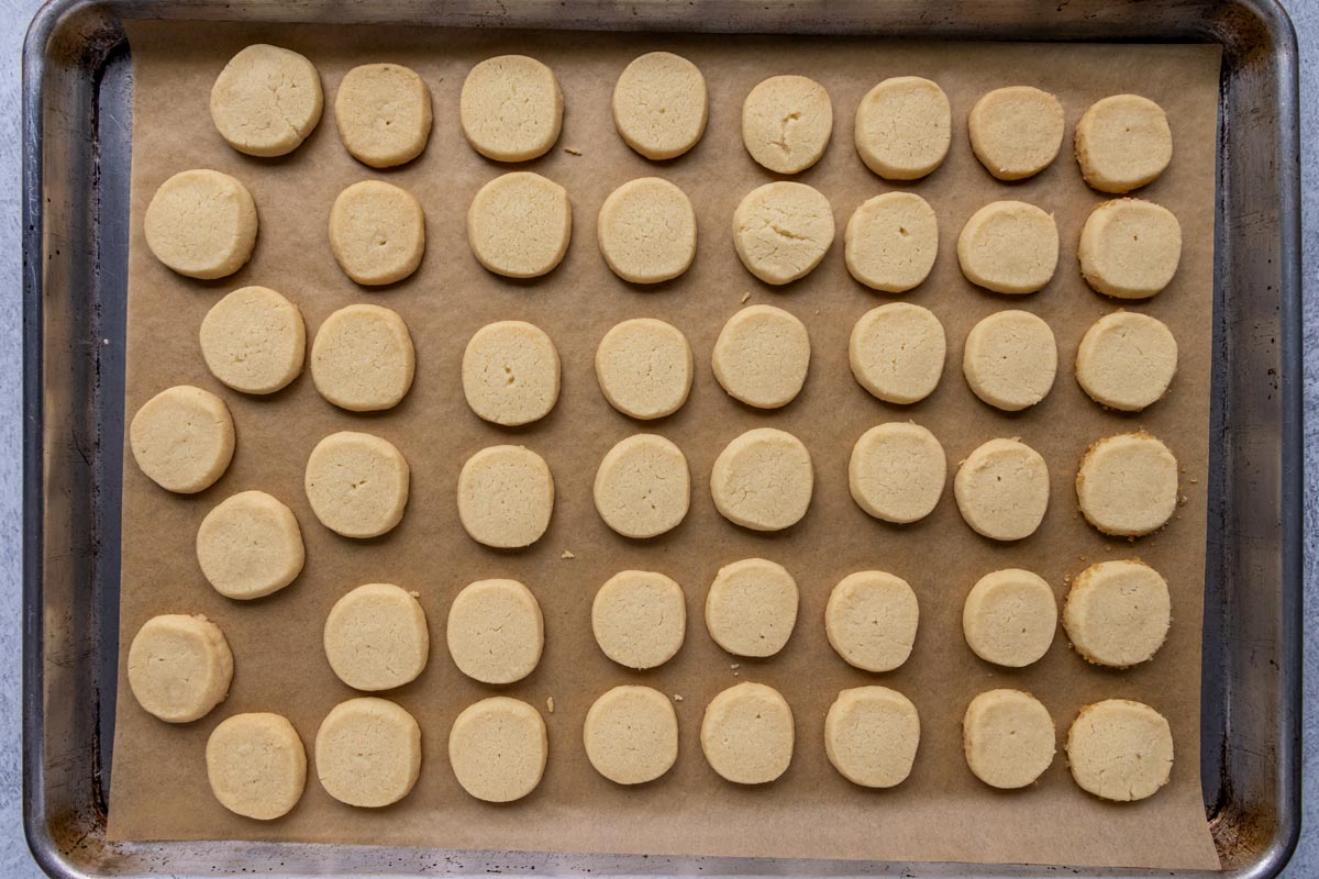 Baked round German shortbread cookies on a baking sheet.