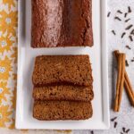 Ontbijtkoek (Dutch breakfast cake) with a few slices cut on a white rectangular platter.
