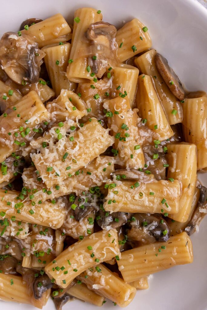Rigatoni tossed in a caramelized onion and mushroom sauce and topped with cheese and chives.