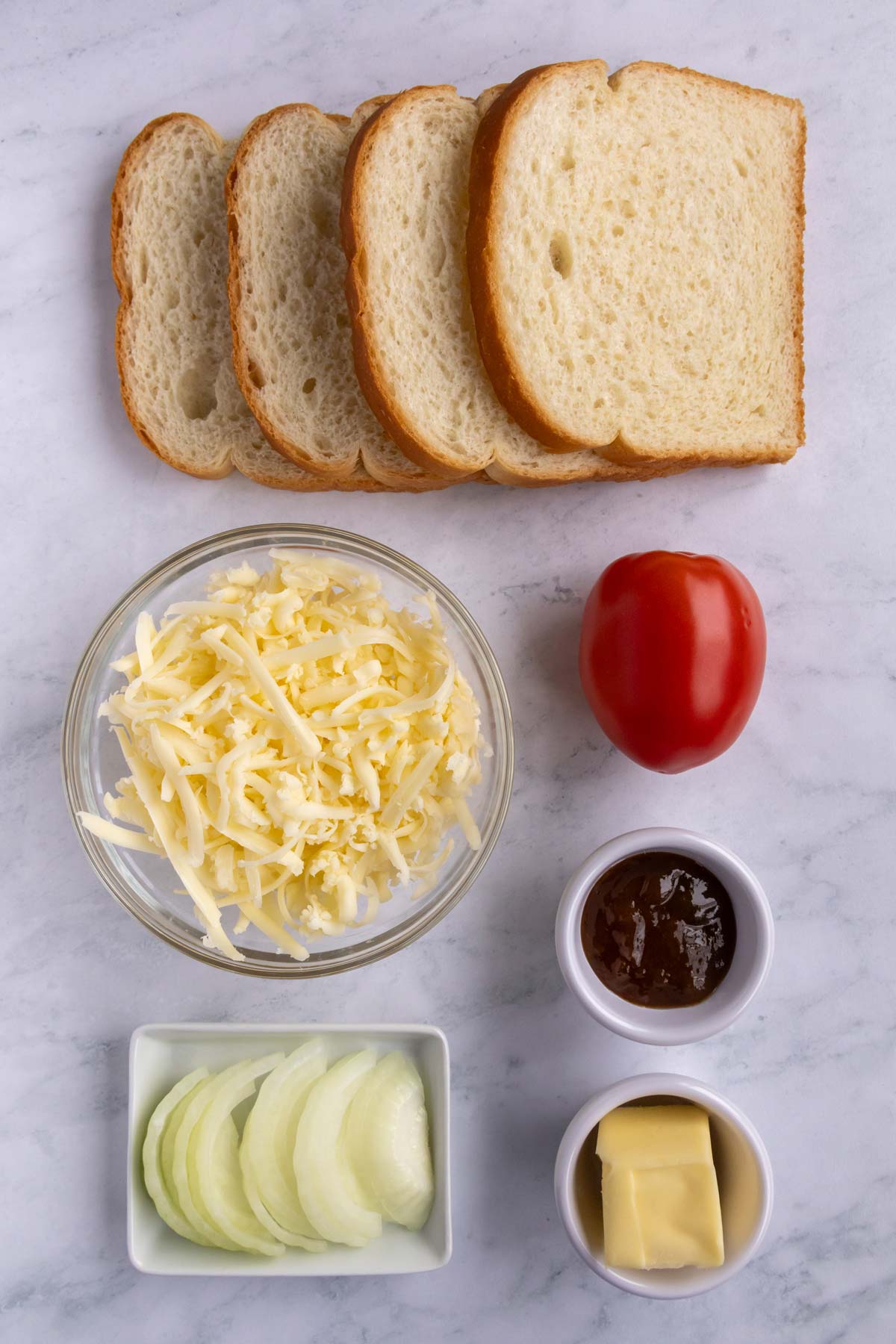 Ingredients for Braaibroodjie on a white marble background.
