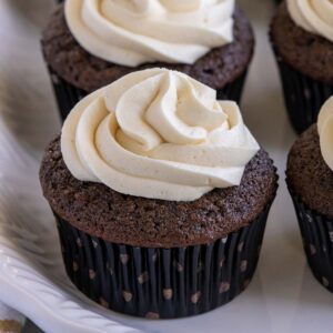 A chocolate Guinness cupcake with Bailey's frosting and a black and white polka dot wrapper.