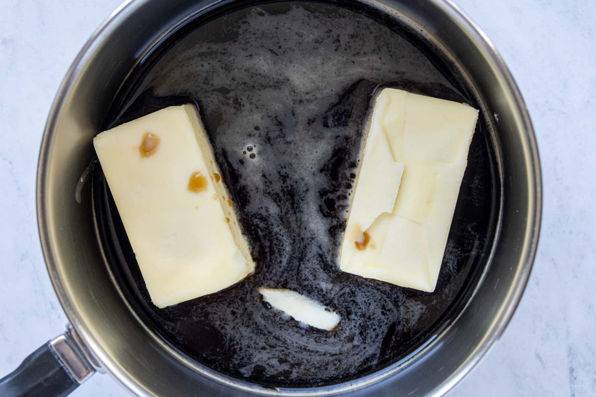 Guinness and two half sticks of butter in a small saucepan before heating to a simmer.