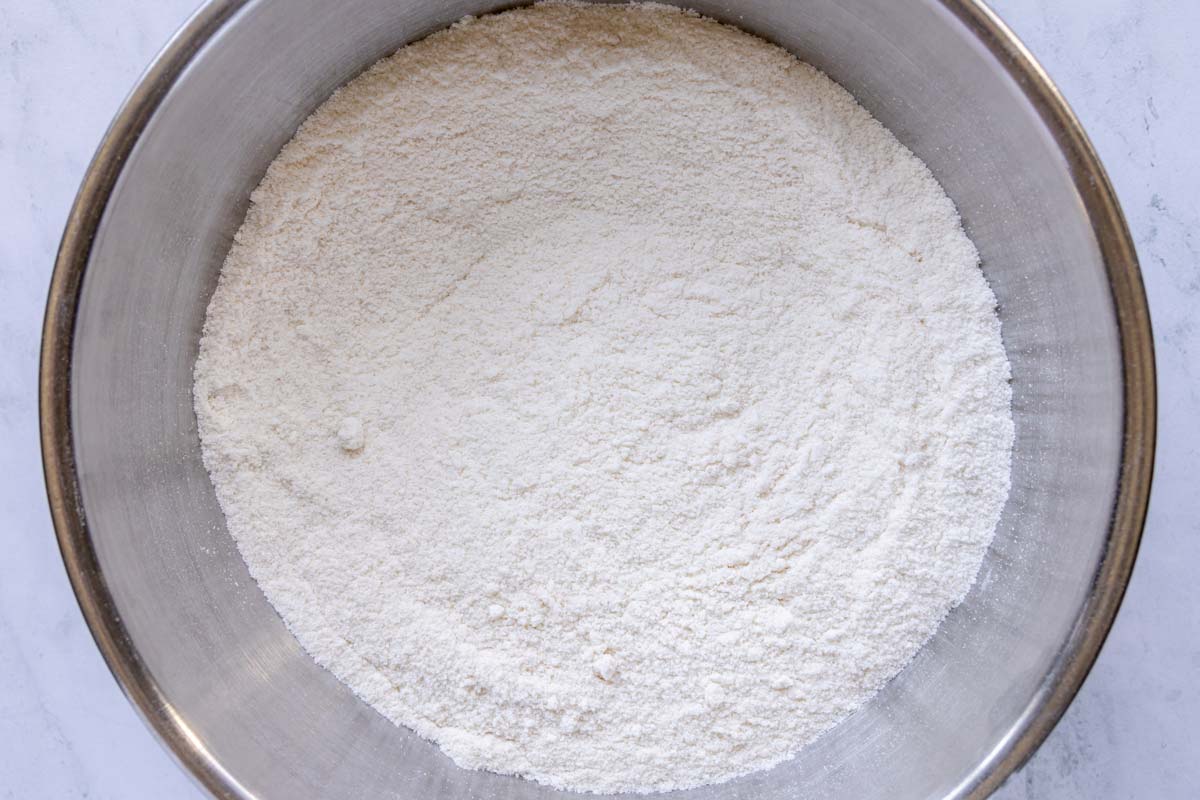 A dry mixture of flour, sugar, baking soda and salt whisked together in a large bowl.