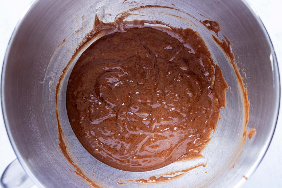 A thick chocolate cupcake batter in a metal mixing bowl.
