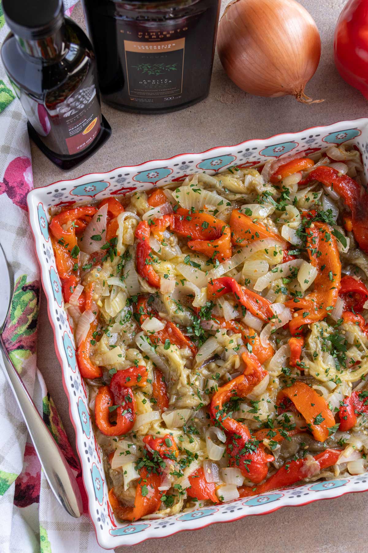 Catalan roasted vegetables (escalivada) served in a colorful square dish.