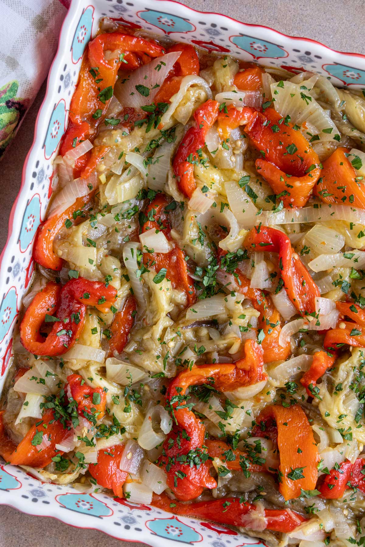 Roasted strips of eggplant, red pepper, and onion, dressed with vinaigrette and topped with parsley.