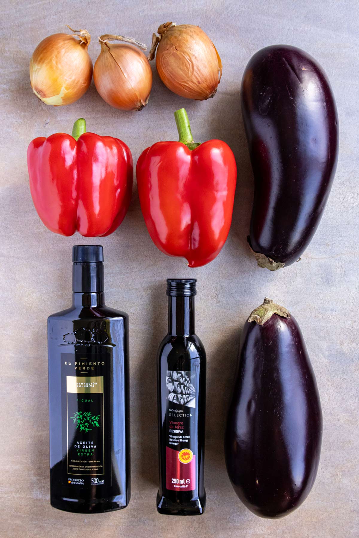 Ingredients for escalivada on a beige background.