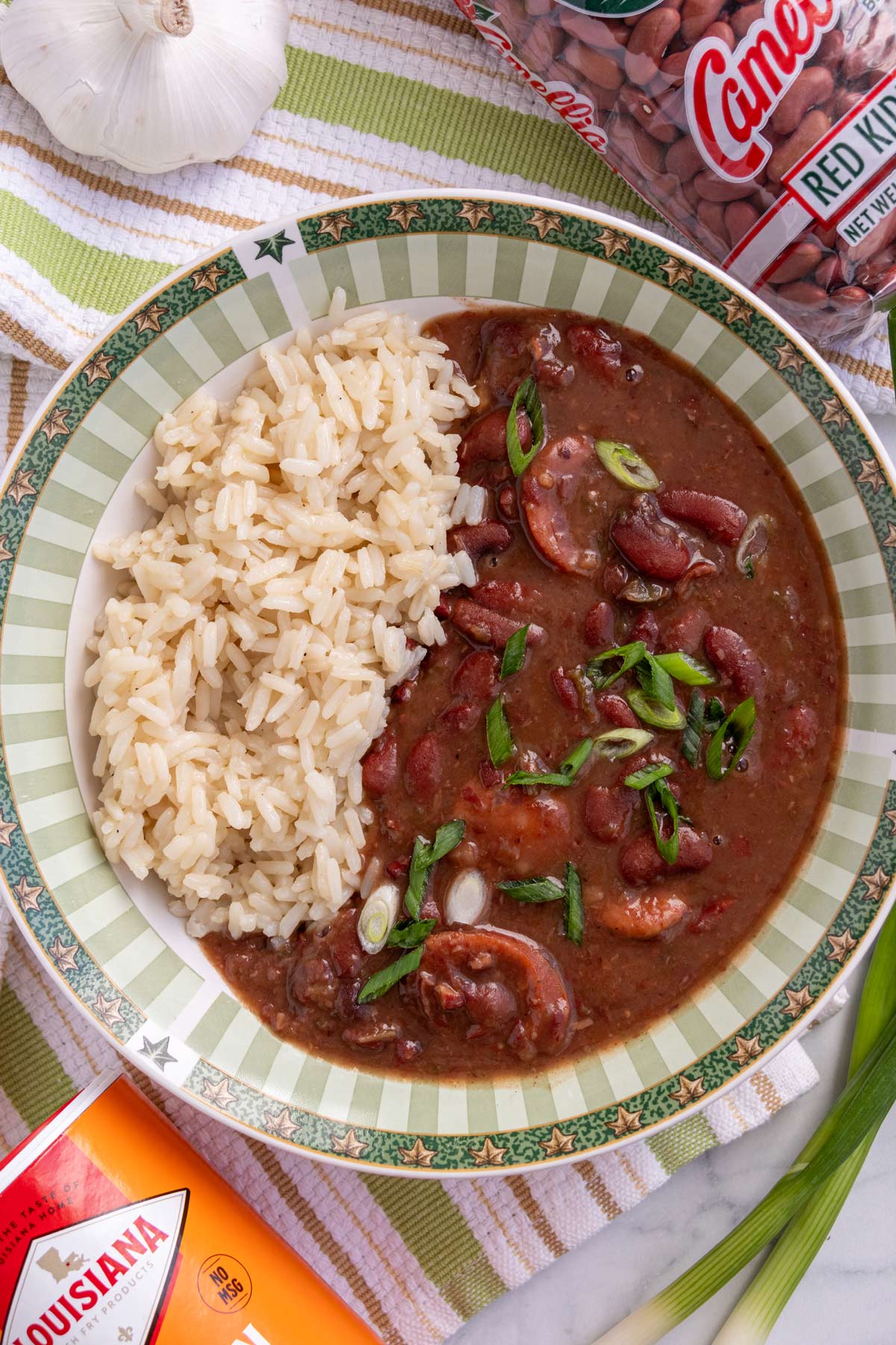 A green and white striped bowl filled with Instant Pot red beans and rice.
