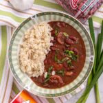 A green and white wide bowl filled with Instant Pot red beans and rice.