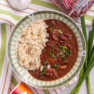 A green and white wide bowl filled with Instant Pot red beans and rice.