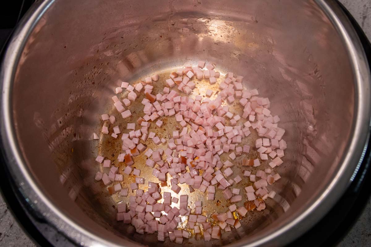 Finely diced ham added to an Instant Pot.