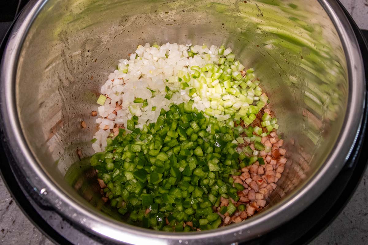Diced onion, celery, and green pepper added to an Instant Pot.
