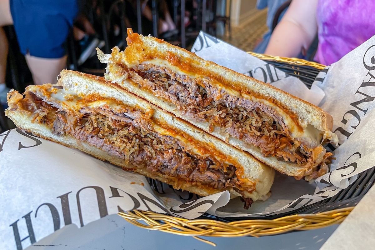 A halved pan con bistec sandwich at Sanguich de Miami, served in a basket.