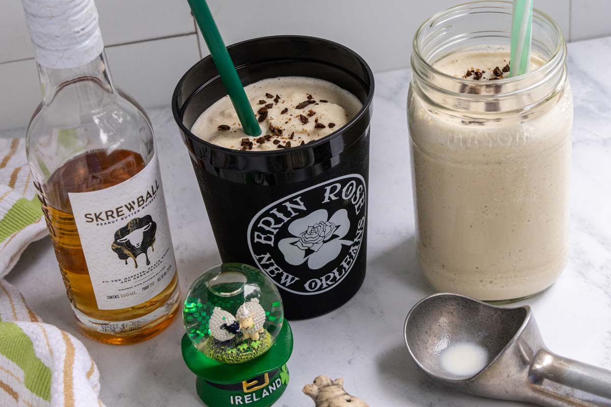 Two cups of frozen Irish coffee, a bottle of peanut butter whiskey, and an Irish snow globe.