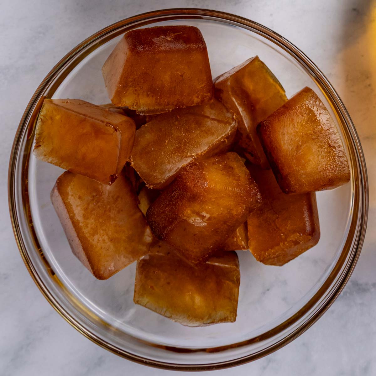 Coffee ice cubes in a glass bowl.