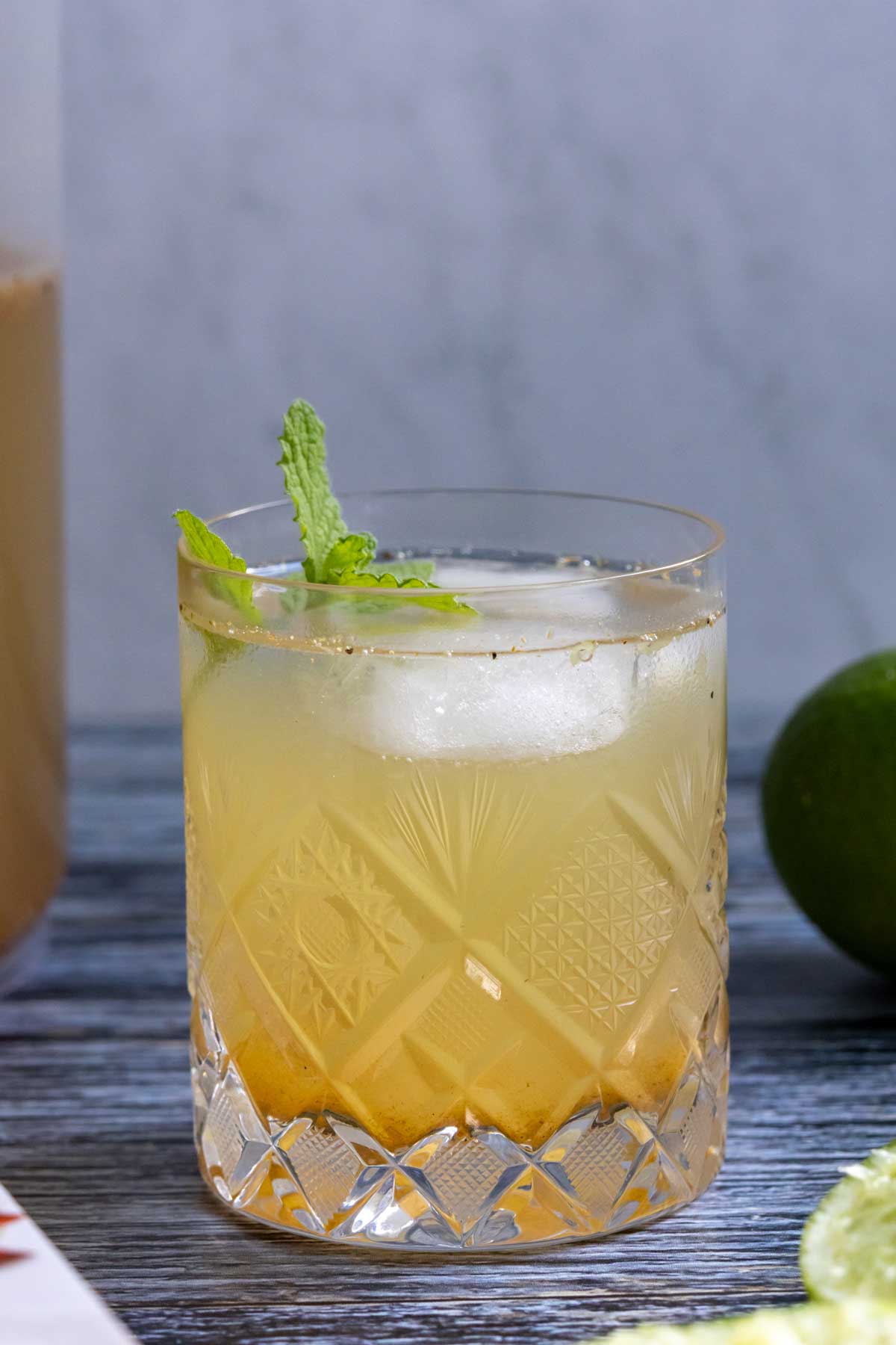 Shikanji Indian lemonade in a crystal glass with a mint garnish.