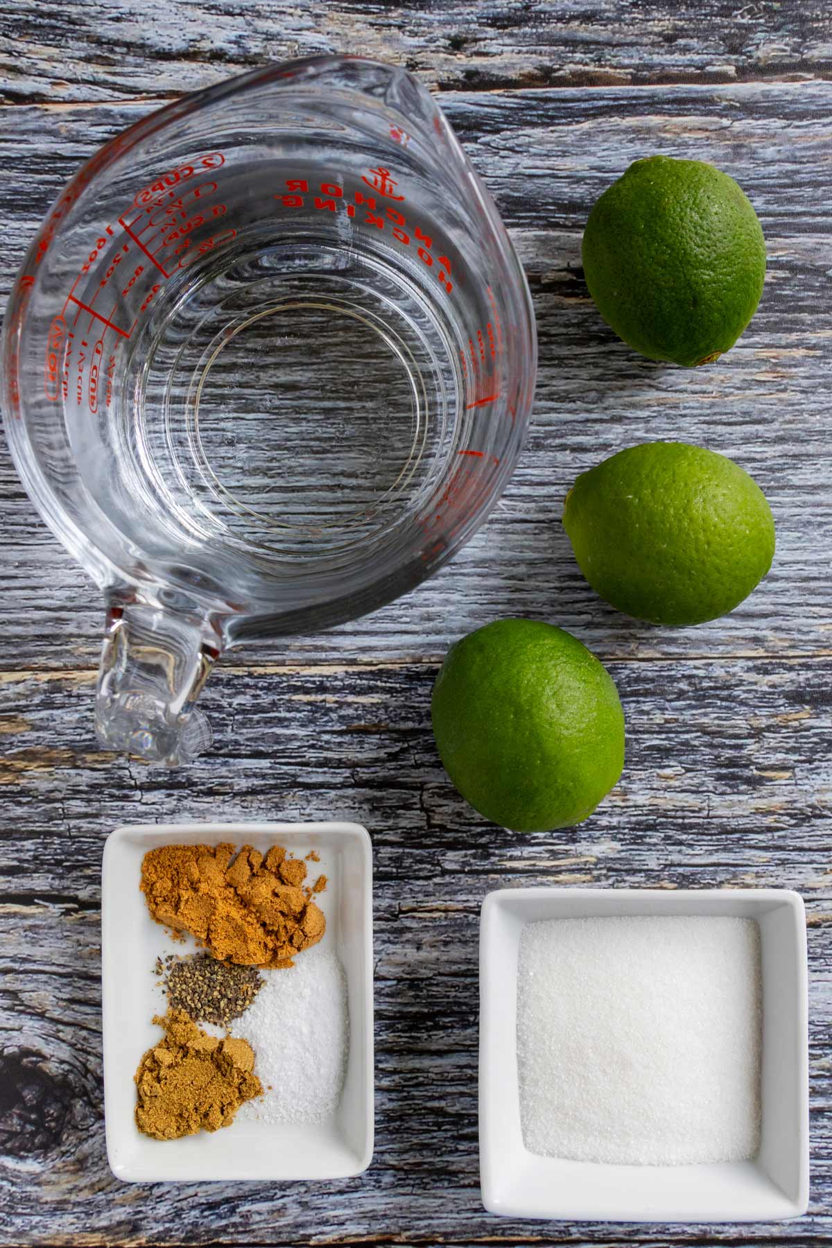 Ingredients for Shikanji / Nimbu Pani on a grey wooden background.