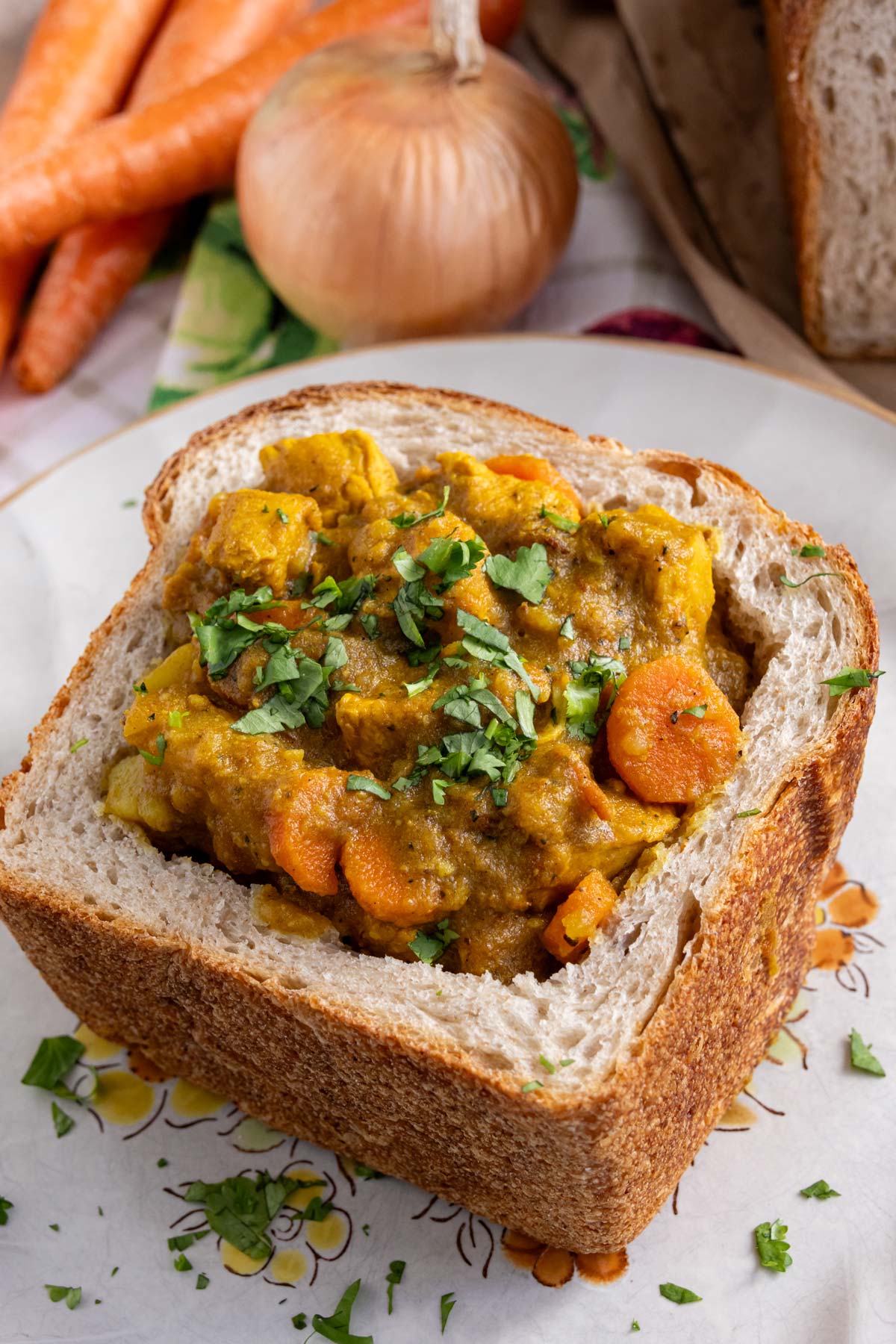 A hollowed out chunk of sandwich bread filled with Durban-style chicken curry.