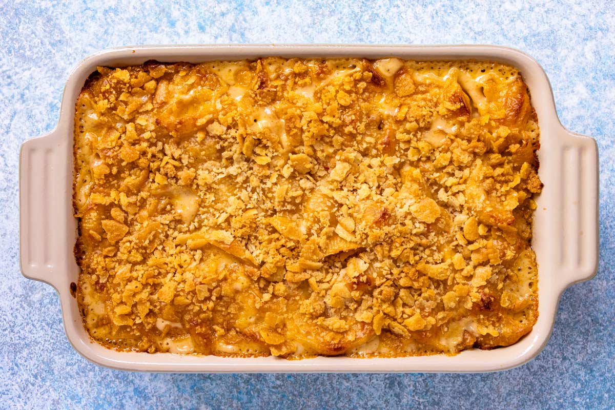 A rectangular casserole dish of baked Cajun macaroni and cheese topped with Ritz crackers.