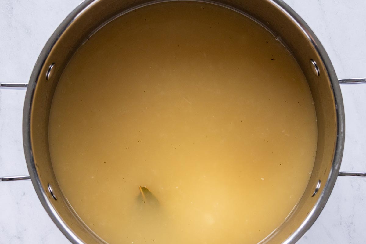 Brothy soup in a large pot.