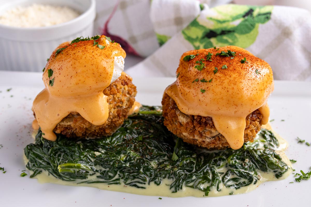 Creamed spinach topped with breaded, fried artichoke bottoms, poached eggs, and sauce choron.