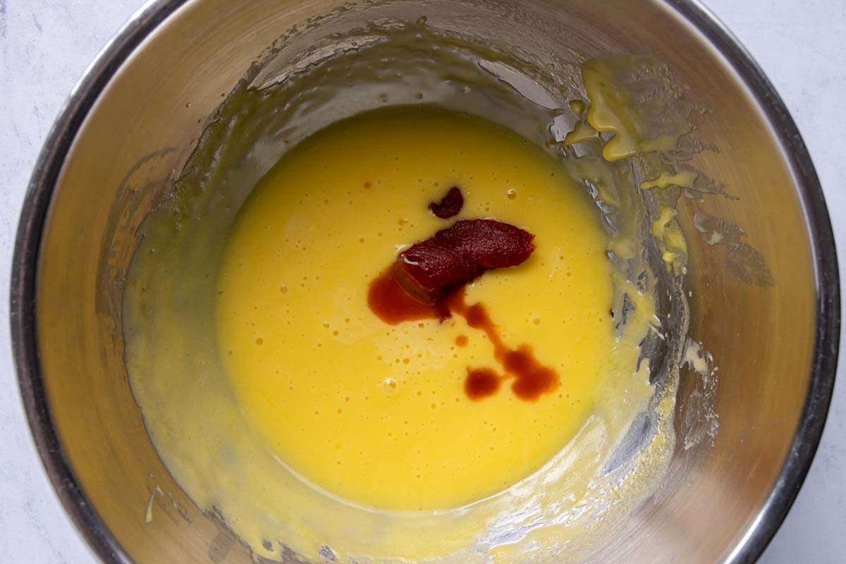 Tomato paste, hot sauce and water added to a bowl of Hollandaise sauce.