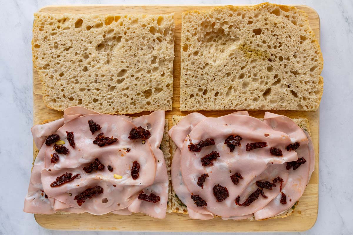 Chopped sun-dried tomatoes added to a couple mortadella sandwiches.