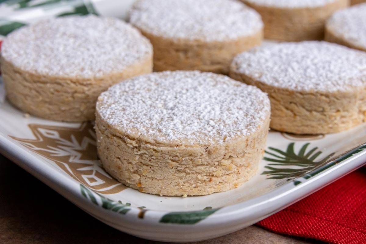 Crumbly Spanish polvorones shortbread cookies on a holiday platter.