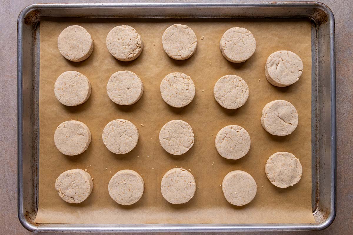 Round cookies baked on a parchment paper-lined baking sheet.