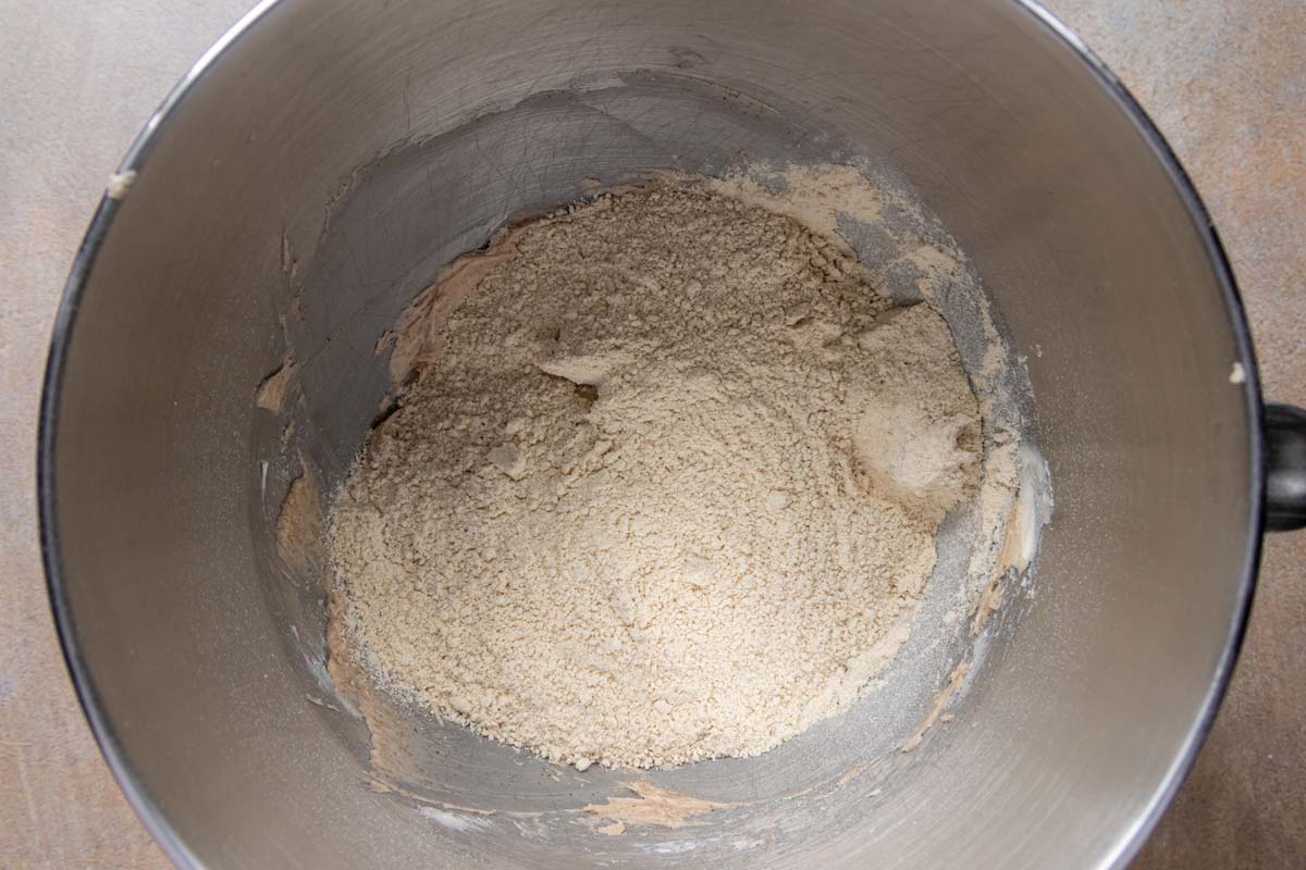 Toasted flour and almond meal added to a mixing bowl.