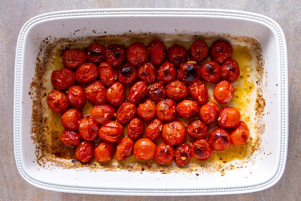 Garlic-roasted cherry tomatoes in a baking dish.