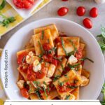 Paccheri pasta with a sauce of cooked cherry tomatoes, fresh basil, and fresh mozzarella cheese.