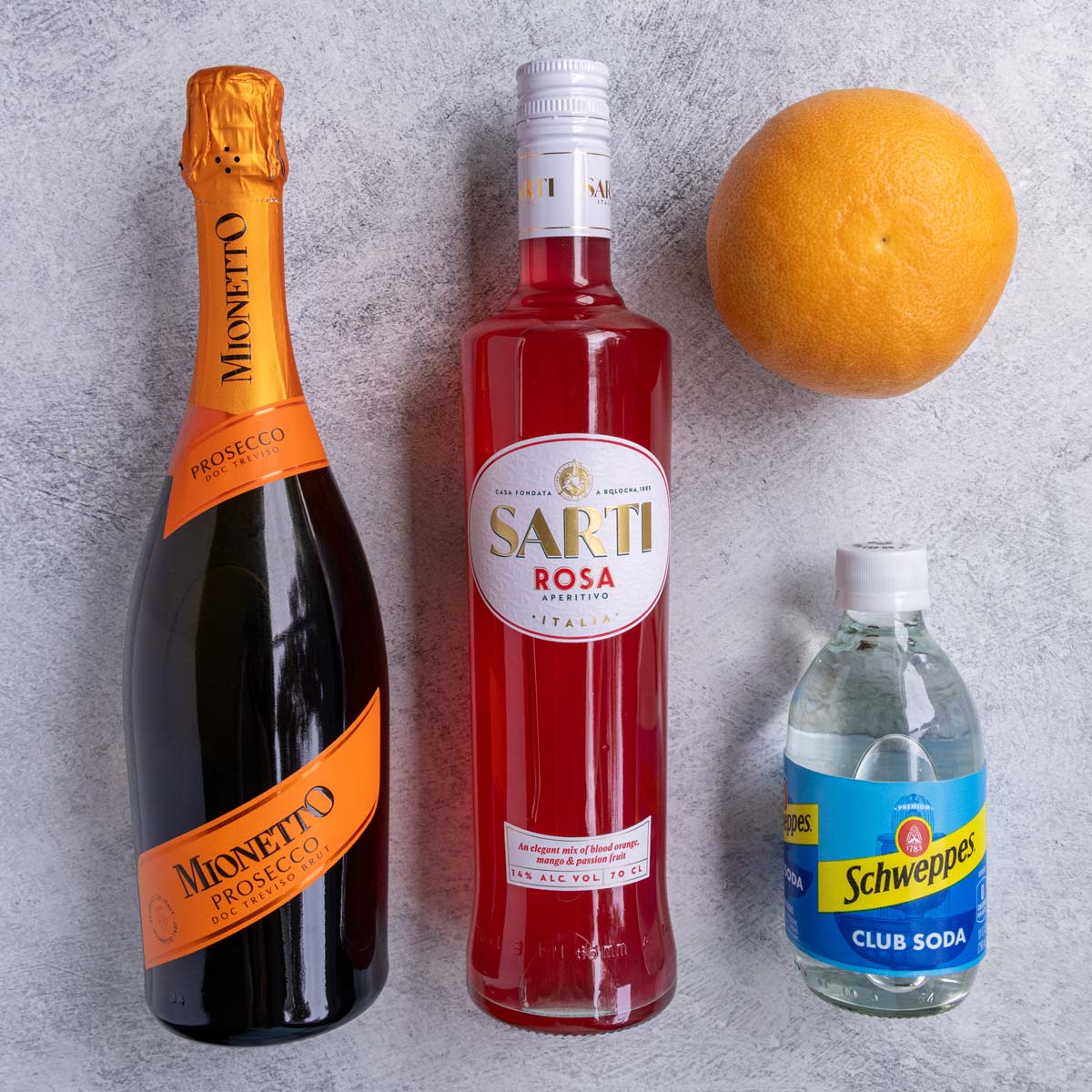 Ingredients for Sarti Spritz on a light grey background.