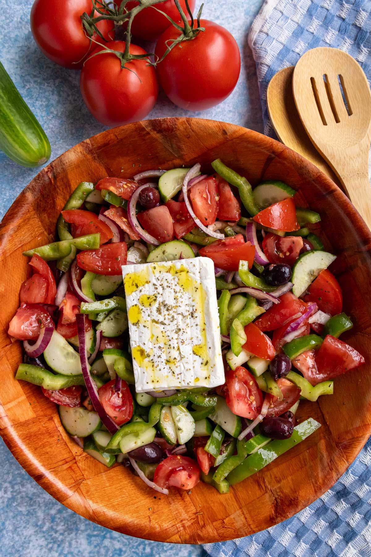 Authentic Greek salad (horiatiki) in a woven wood salad bowl.