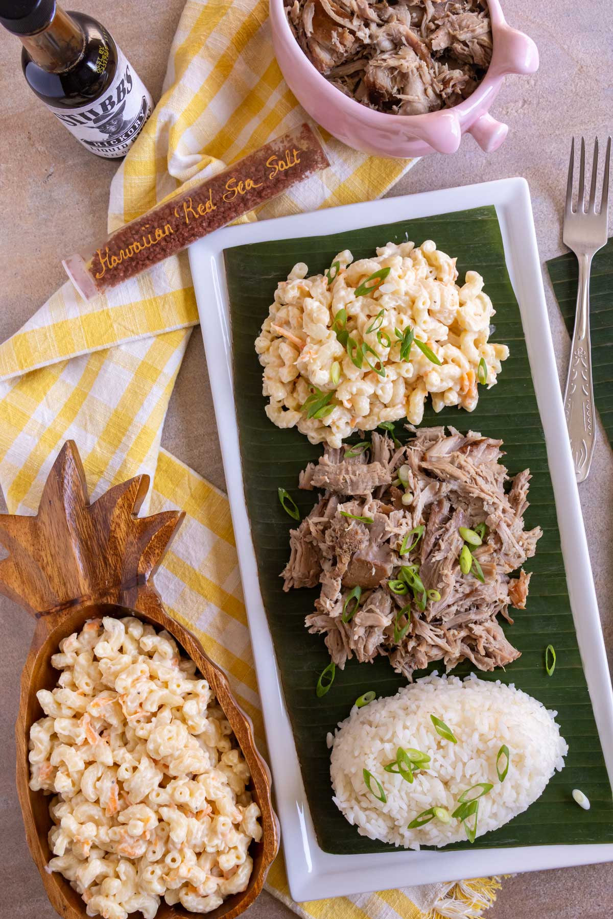 Kalua pork served with Hawaiian mac salad and plain white rice on a rectangular dish.